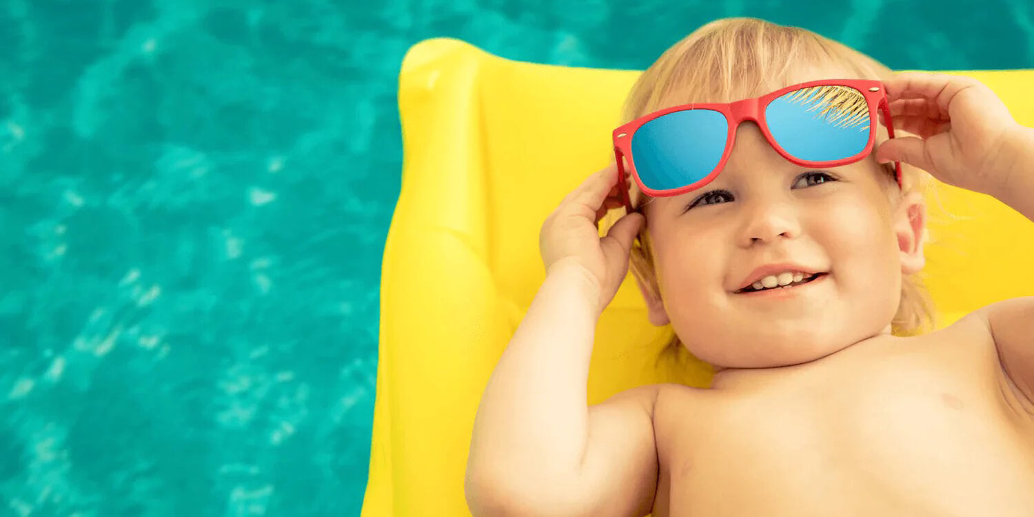 toddler boy summer fun in pool